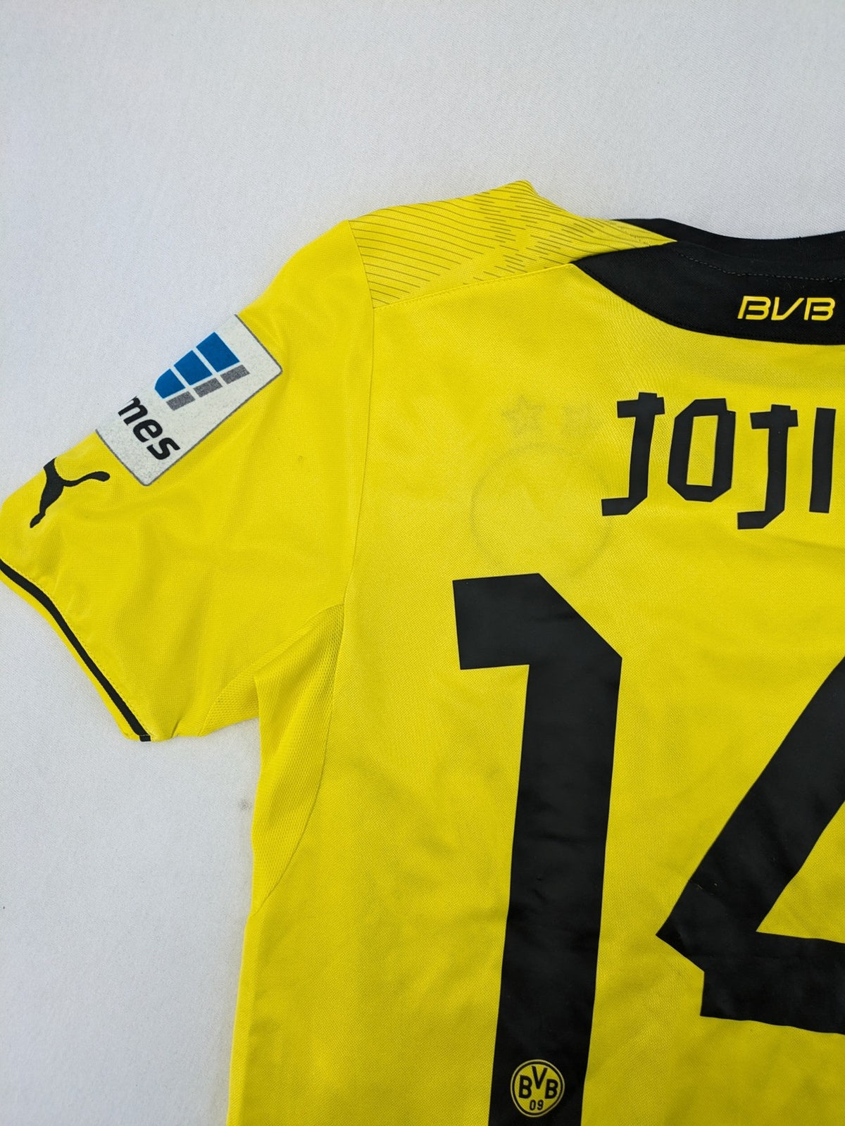 Borussia Dortmund black and yellow soccer uniform with DFB Pokal 2014 patch and Puma logo.