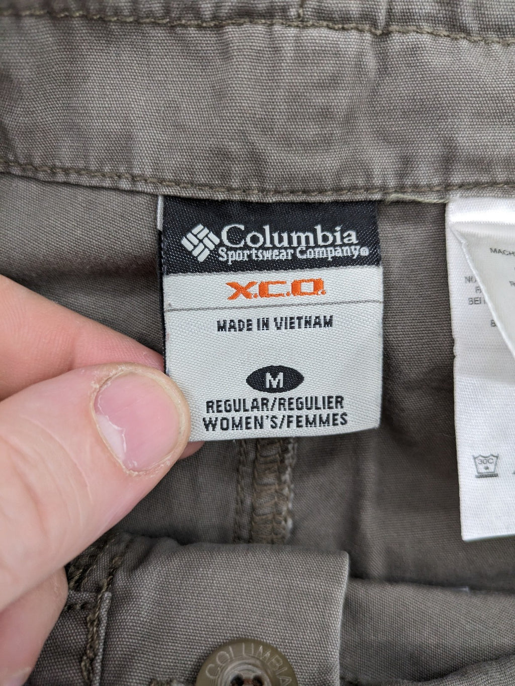 Columbia grey cargo pants with multiple pockets and drawstring waist, 100% cotton.