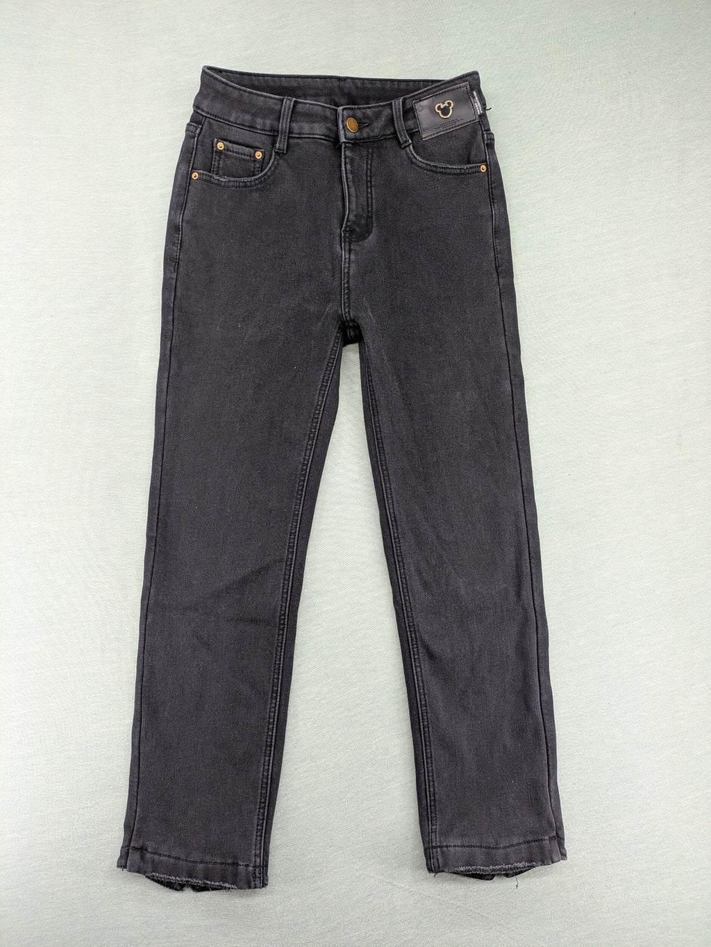 Disney black straight jeans with Minnie Mouse detail, cropped length, stretchy cotton blend.