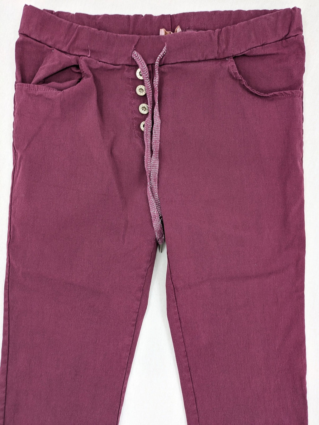 Pink Cherry pants pink stretchy fabric with decorative buttons and elastic waistband.