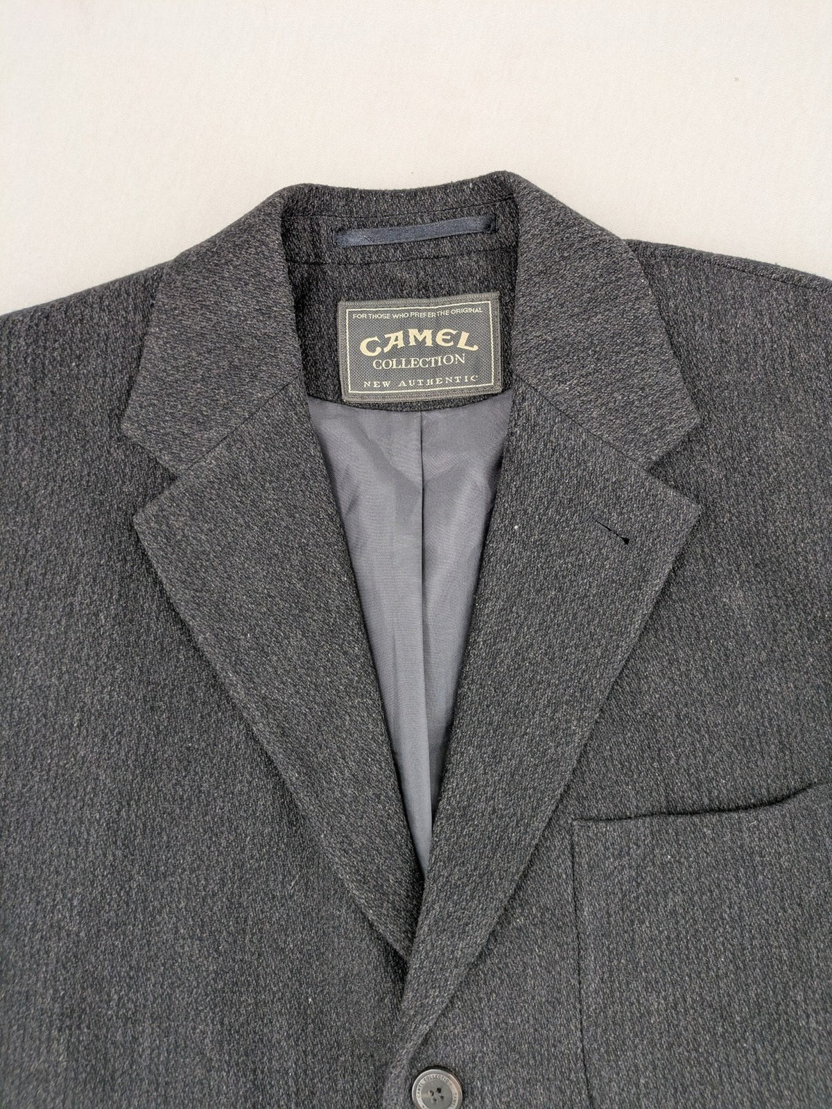 Camel Collection grey blazer three-button front with patch pockets, made from wool blend.