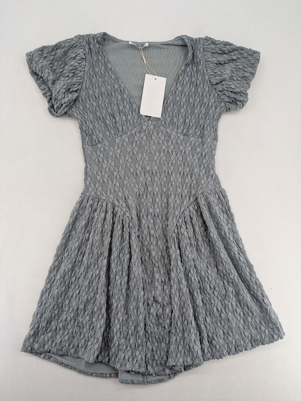 Zara grey mini dress with V-neck, puff sleeves, and textured fabric pattern.
