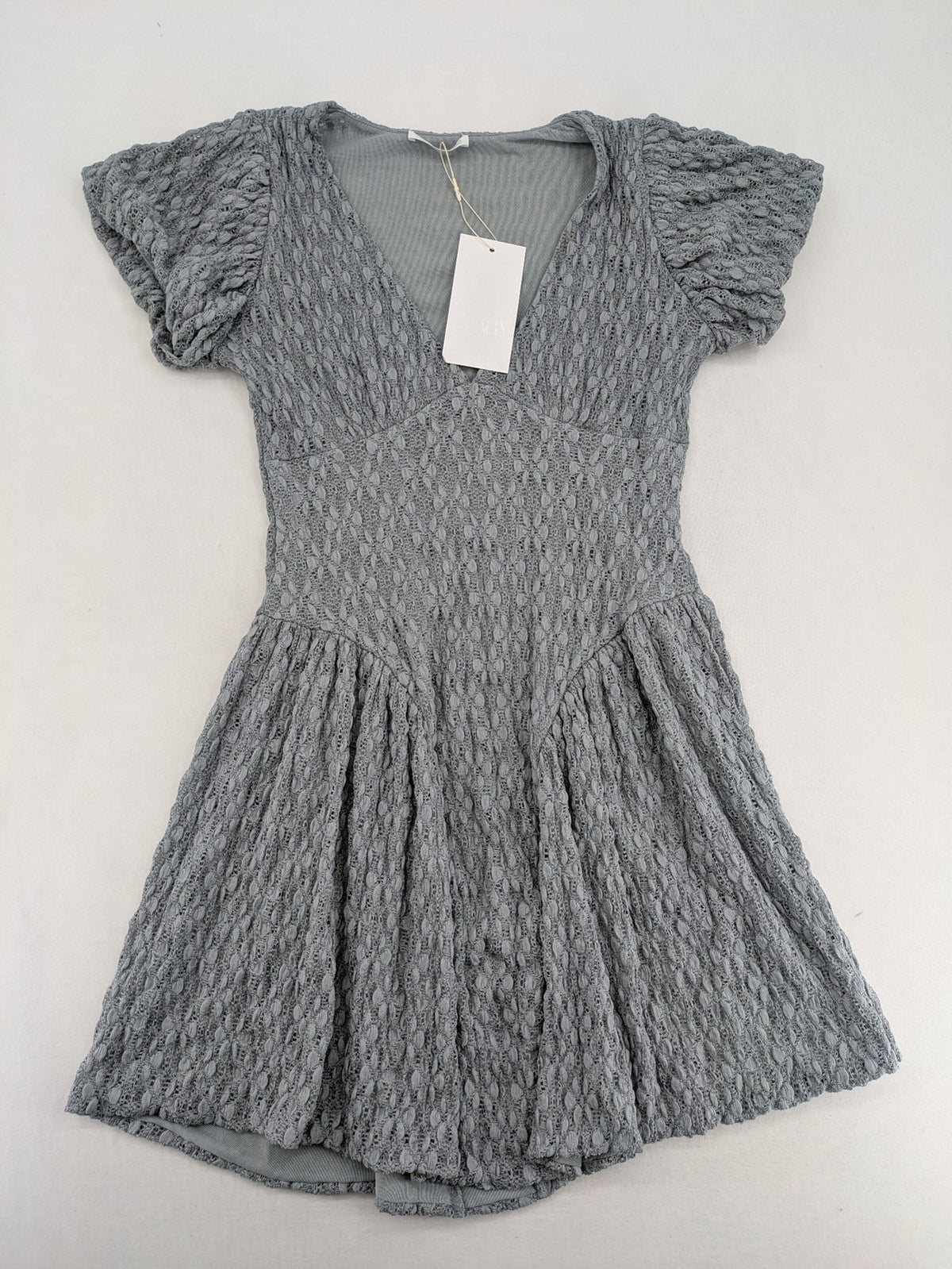 Zara grey mini dress with V-neck, puff sleeves, and textured fabric pattern.