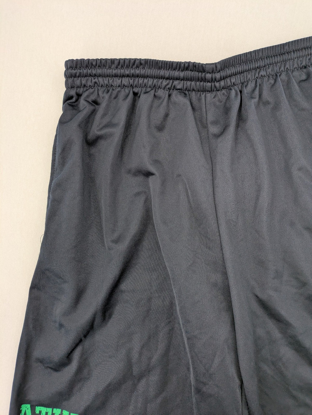 okay grey cargo shorts with green "ATHL. 5 DIVISION" graphic print and side pocket.
