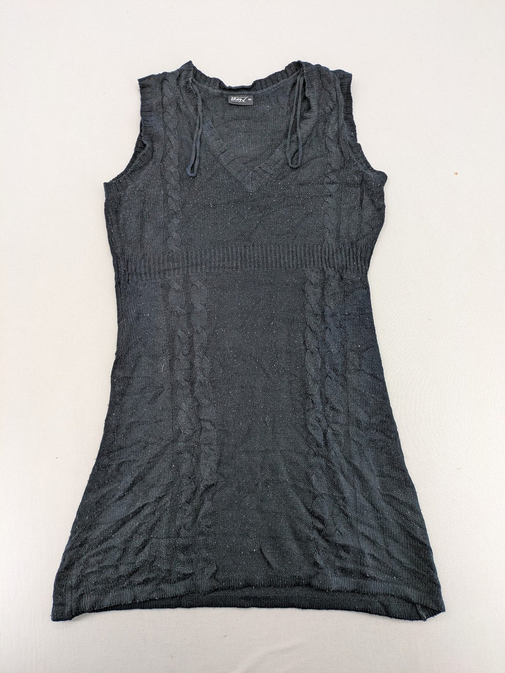 Okay black sleeveless dress V-neck with decorative cord and cable knit pattern.