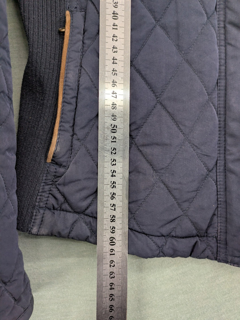 Massimo Dutti black quilted jacket with contrasting brown trim and ribbed side inserts.