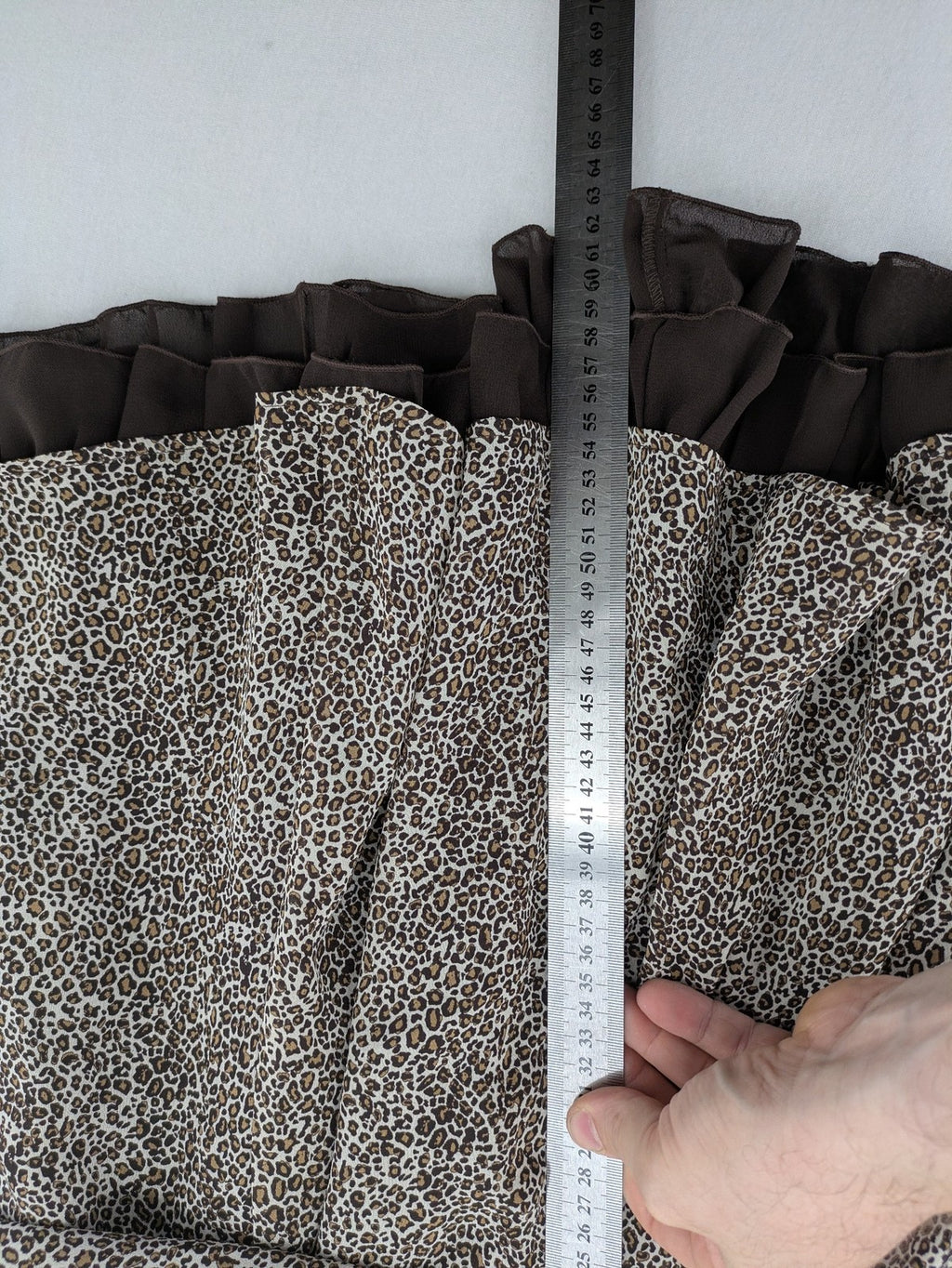 H&M women's A-line skirt beige brown leopard print ruffled hem and side tie detail.