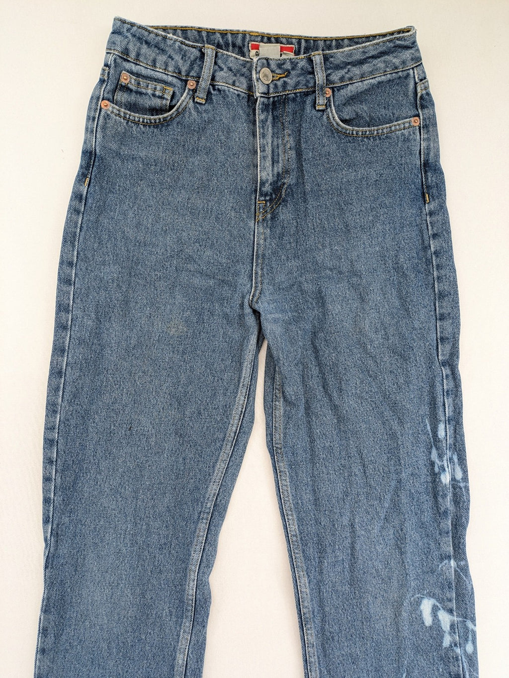 Castro Jeans blue straight leg jeans high waist with white paint splatter details.