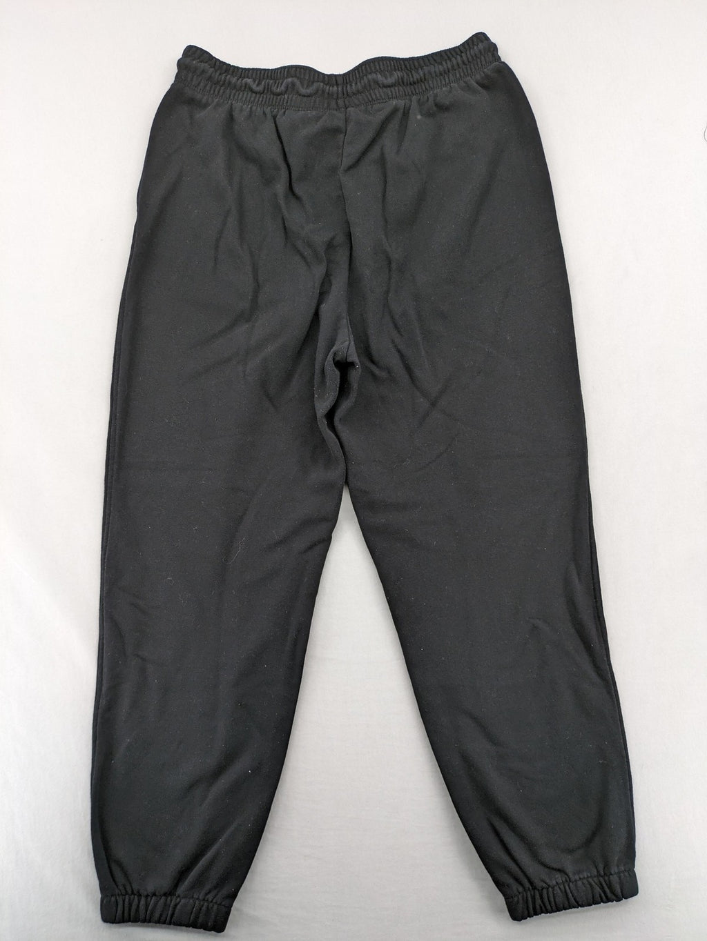 H&M black sweatpants with adjustable drawstring, elastic cuffs, and side pockets.