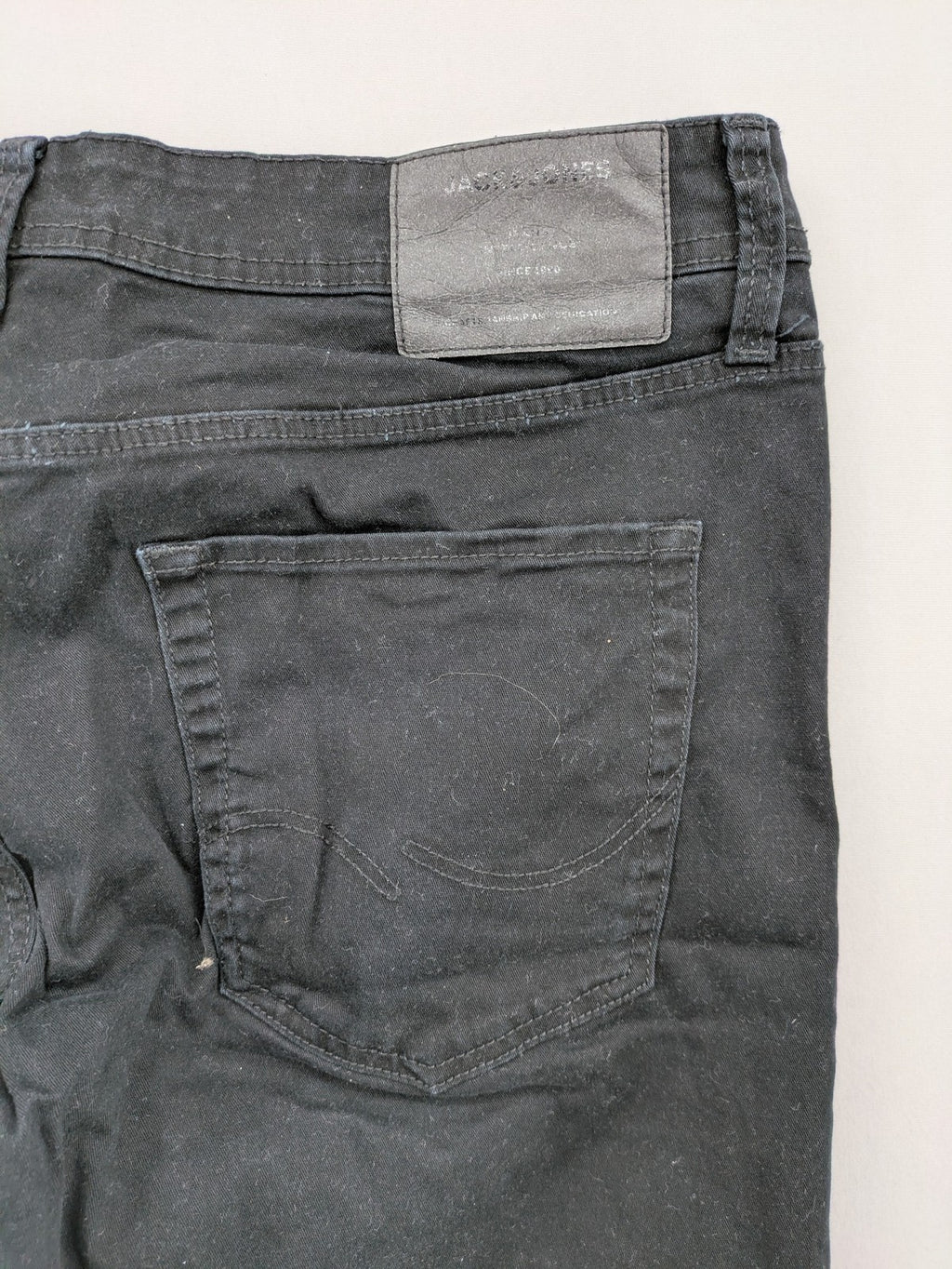 Jack & Jones black slim fit jeans with logo patch and cotton-stretch blend.