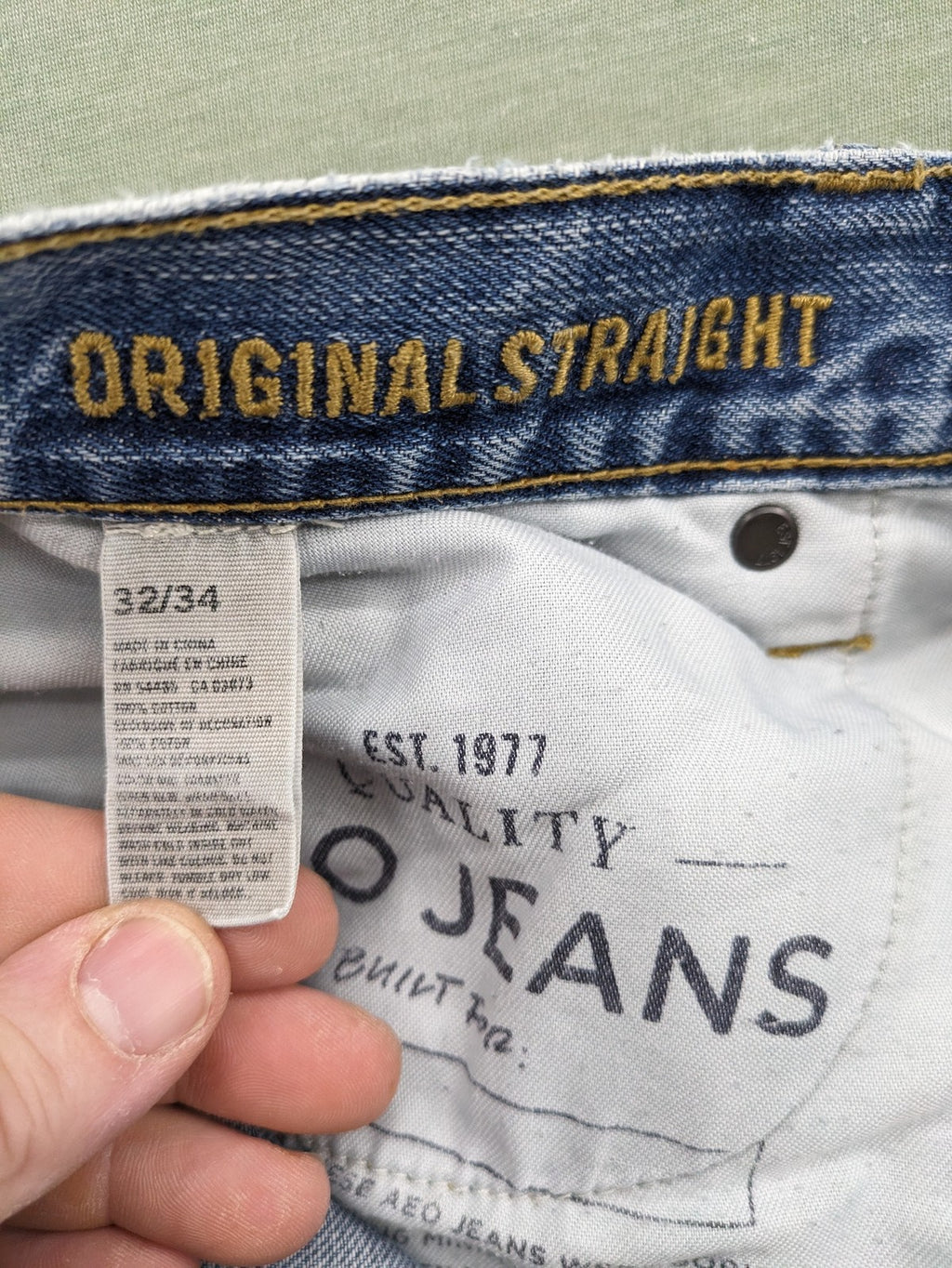American Eagle Outfitters blue straight jeans with distressed detailing and classic five-pocket design.