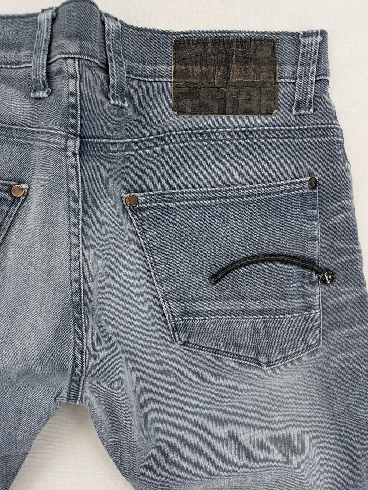 G-Star Raw grey denim straight jeans with classic button fly and subtle branding details.