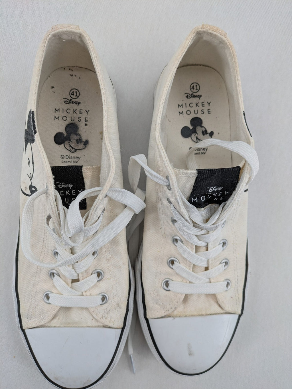 Disney Mickey Mouse white canvas low top sneakers with iconic Mickey Mouse graphic.