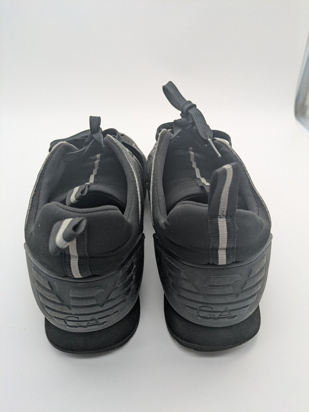 EA7 Emporio Armani beige and black sneakers with prominent EA7 branding and breathable mesh details.