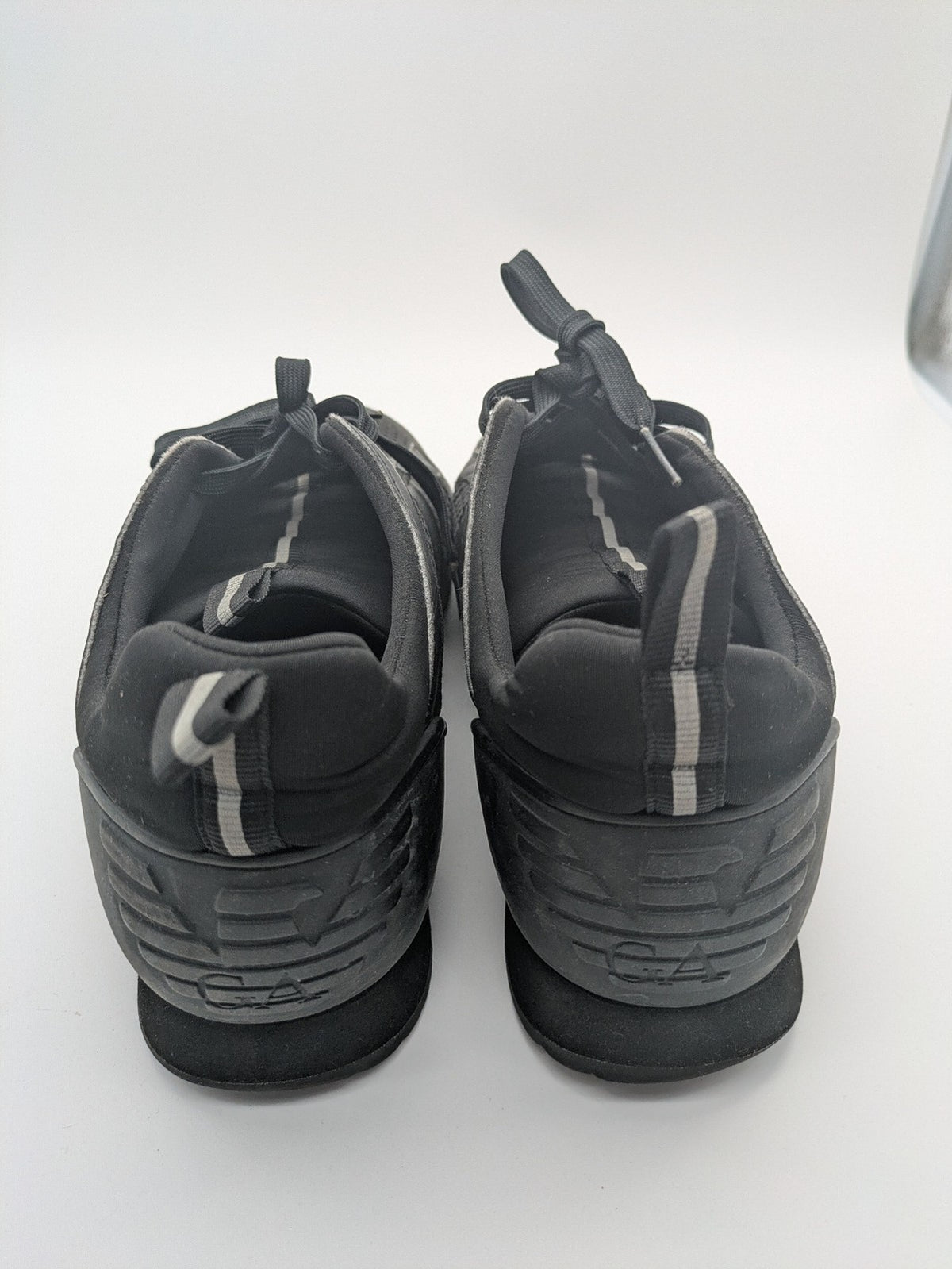 EA7 Emporio Armani beige and black sneakers with prominent EA7 branding and breathable mesh details.