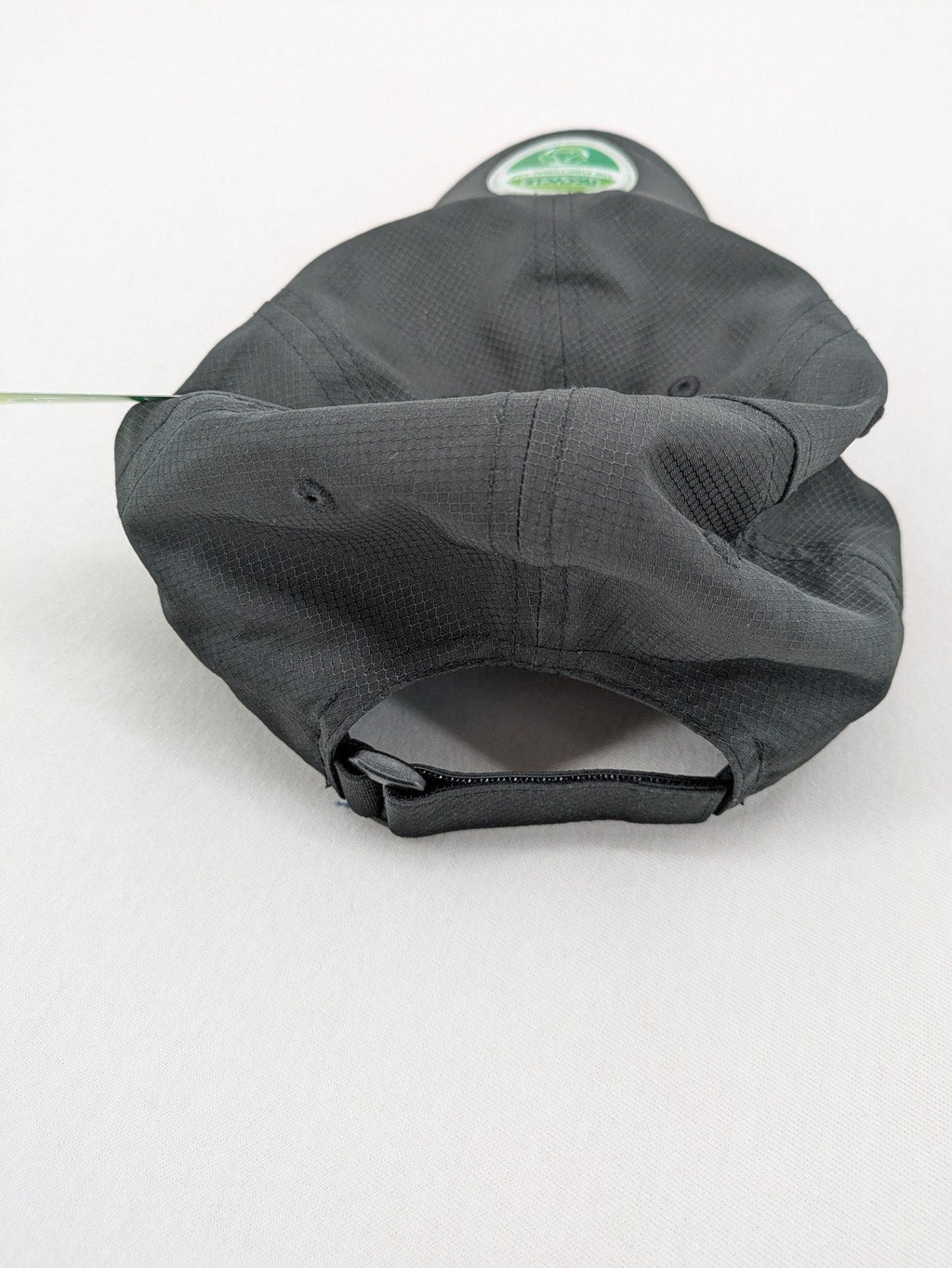 Funktional grey baseball cap with embroidered Dormakaba logo and modern ripstop texture.