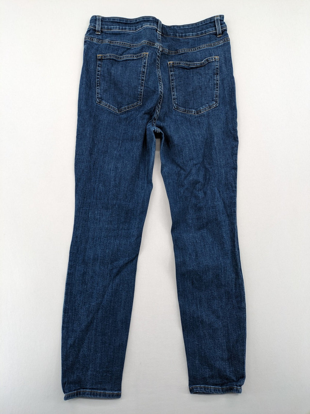 H&M blue skinny jeans with stretch denim and slim fit design.