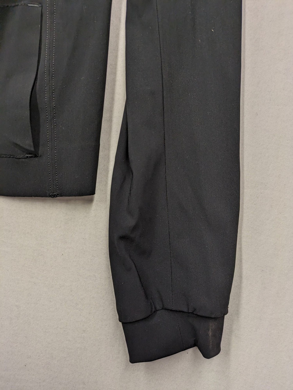 Beate Heymann black biker jacket with asymmetrical front and stand-up collar, stretch material.