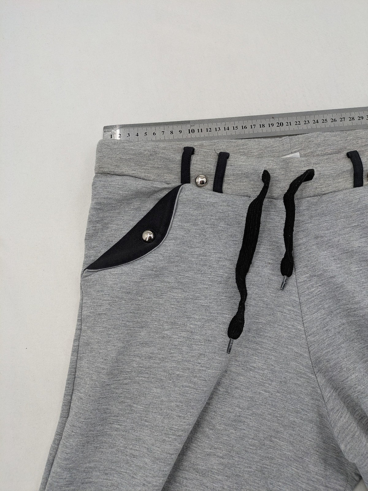 Falconhill grey jogging pants with elastic waistband, drawstring, and stylish black accent pockets.
