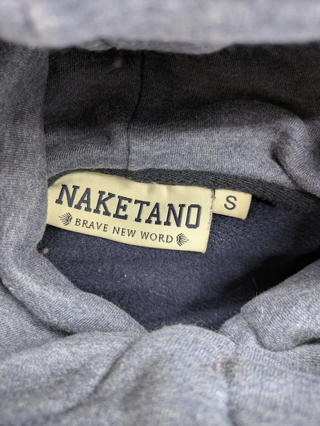 Naketano grey turtle neck jumper with thick drawstring and leather logo appliqué.