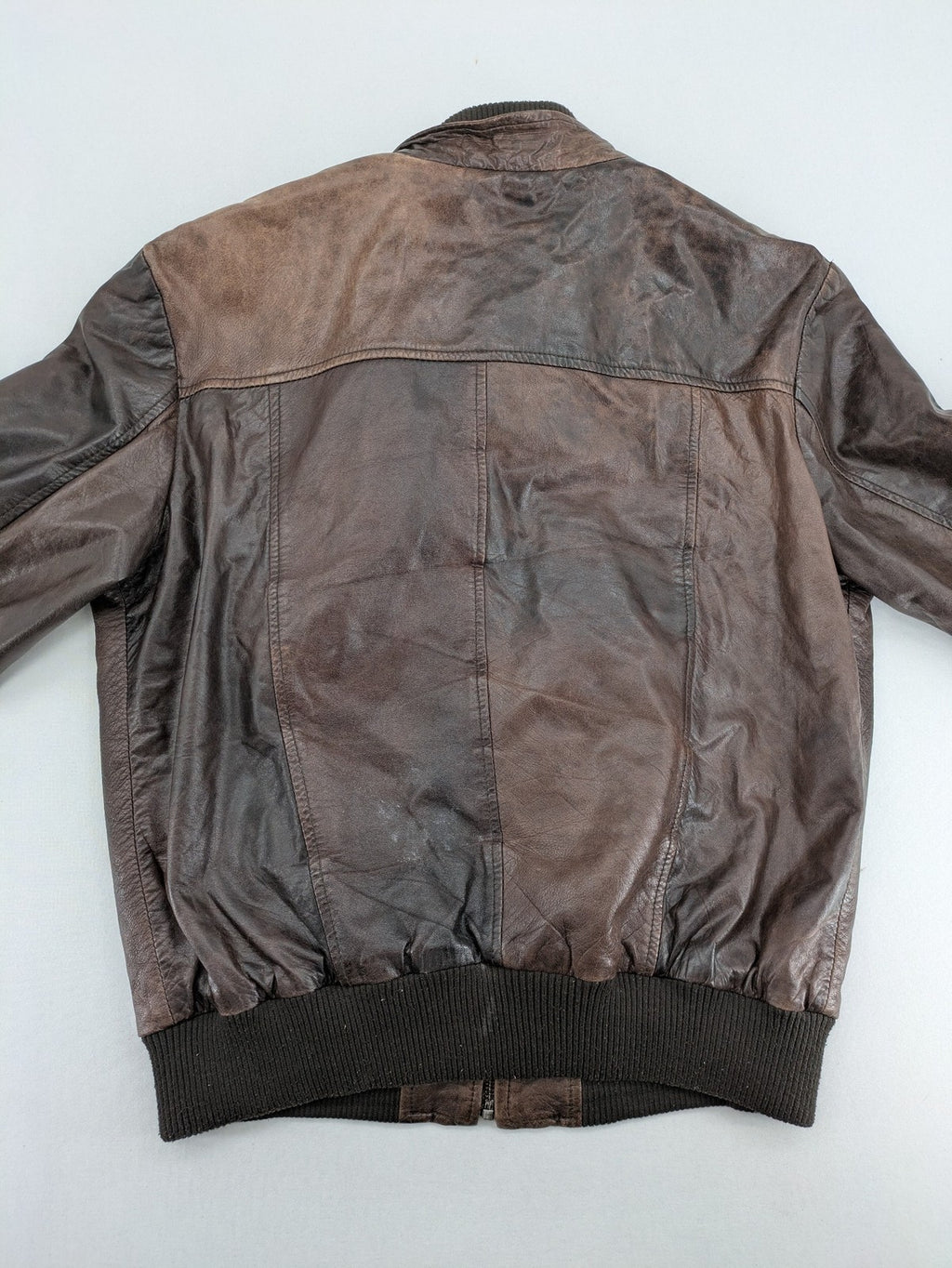 H&M green leather bomber jacket with ribbed collar and moto-style padding.