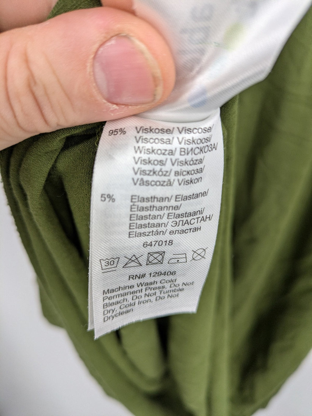 Bonprix green maternity dress with layered V-neck and empire waist design.