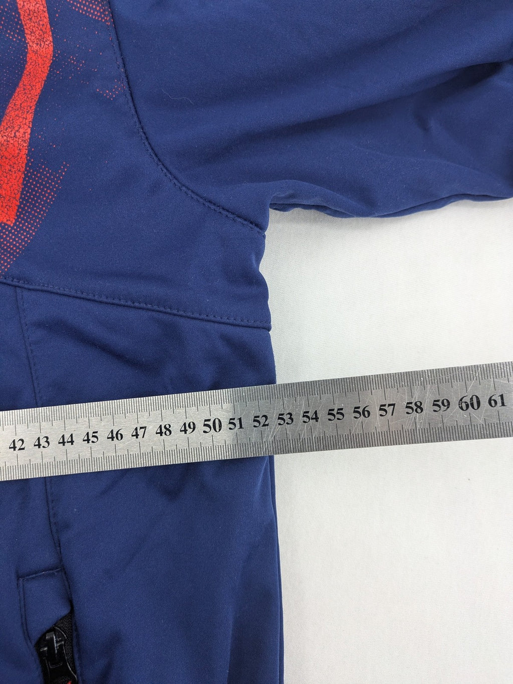 Firefly blue softshell jacket with adjustable hood and prominent chest logo.