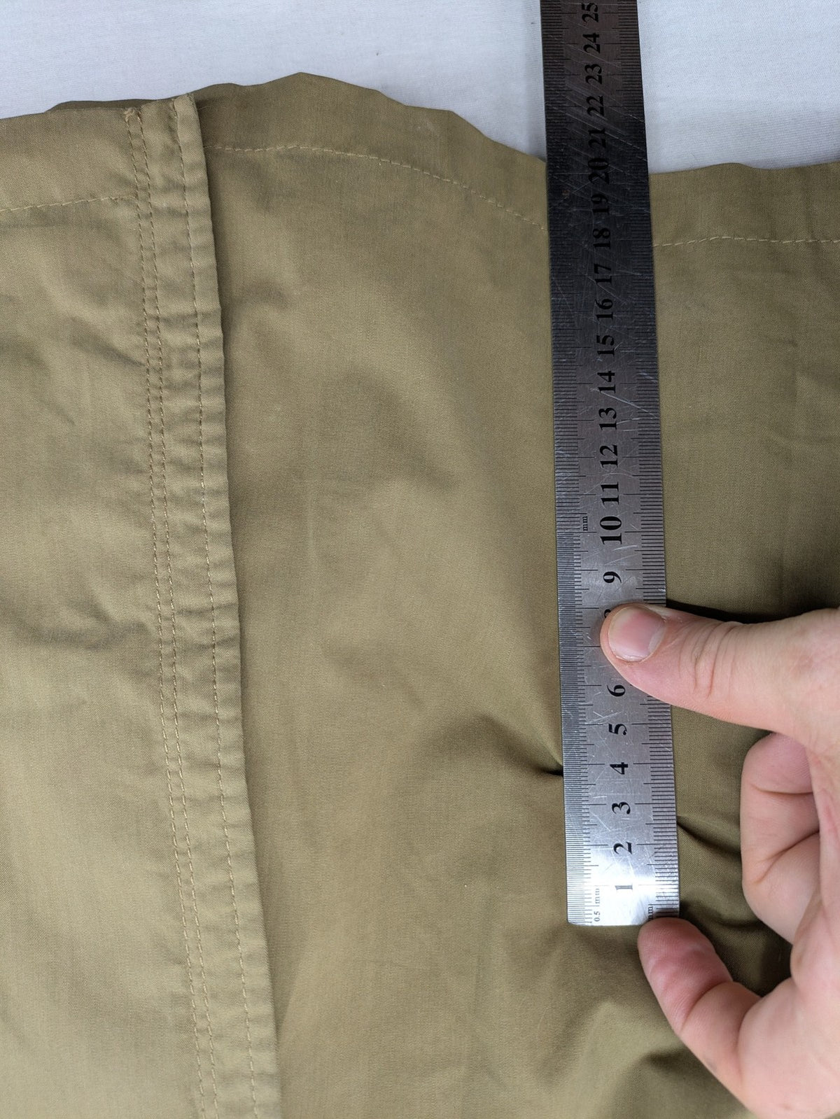 Studio Novum khaki trench coat double-breasted design with belt and wool lining.