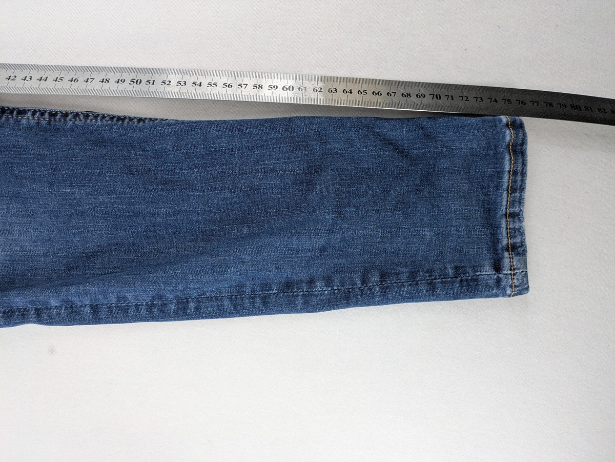 H&M blue skinny jeans with distressed details and comfortable stretch denim material.