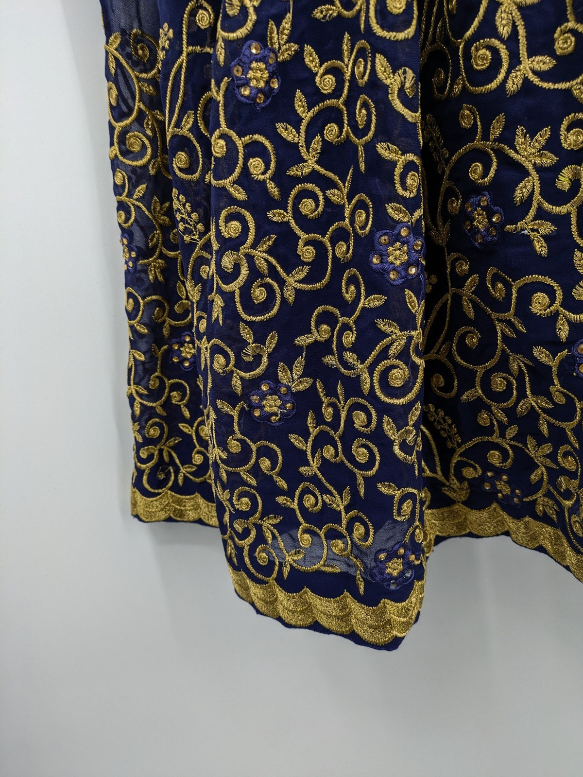 Bollywood bridal party dress gold with intricate blue embroidery and flowing Anarkali silhouette.