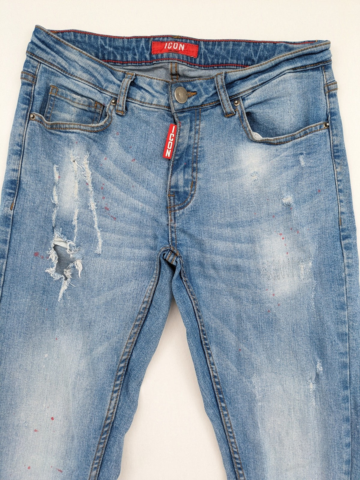 Milano straight jeans light blue distressed with red splatter and extra slim fit.
