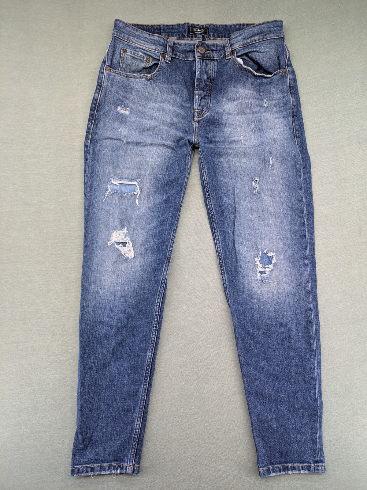 Pull & Bear blue distressed ripped straight jeans with button fly and classic wash.