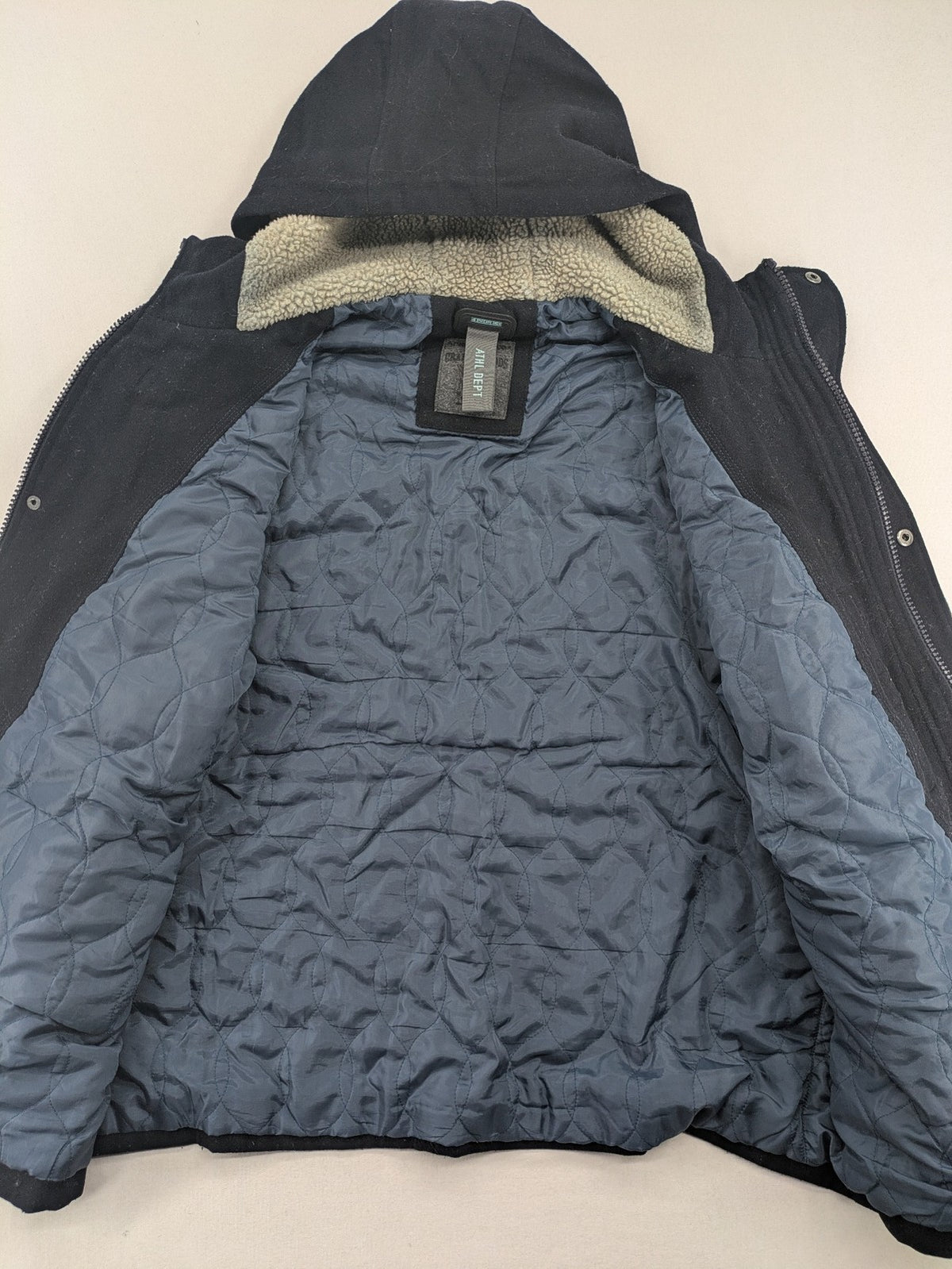 Angelo Litrico black duffle coat with toggle closure and cream Sherpa-lined hood.