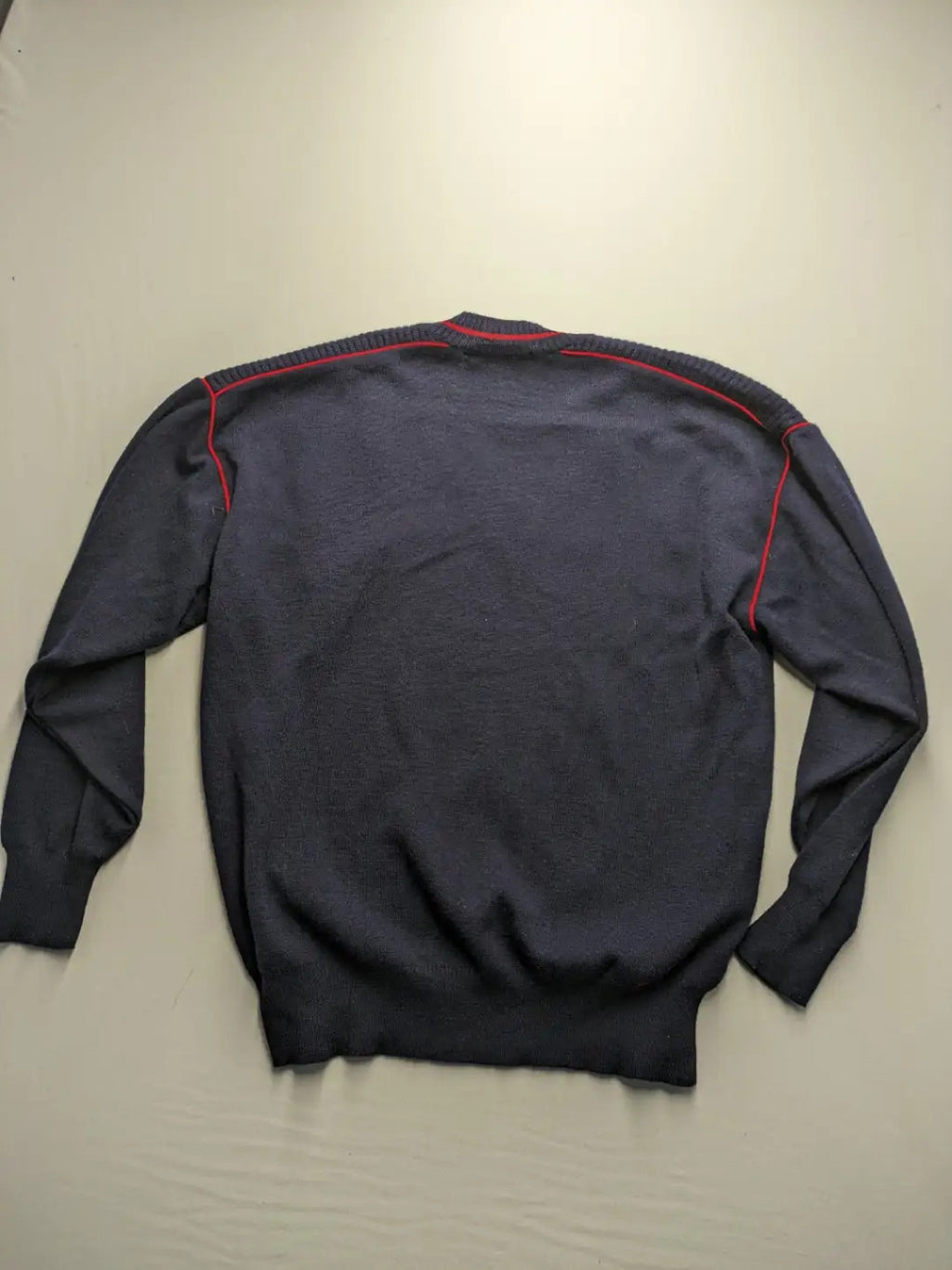Il Granchio grey turtle neck jumper with red accents and embroidered crab logo.