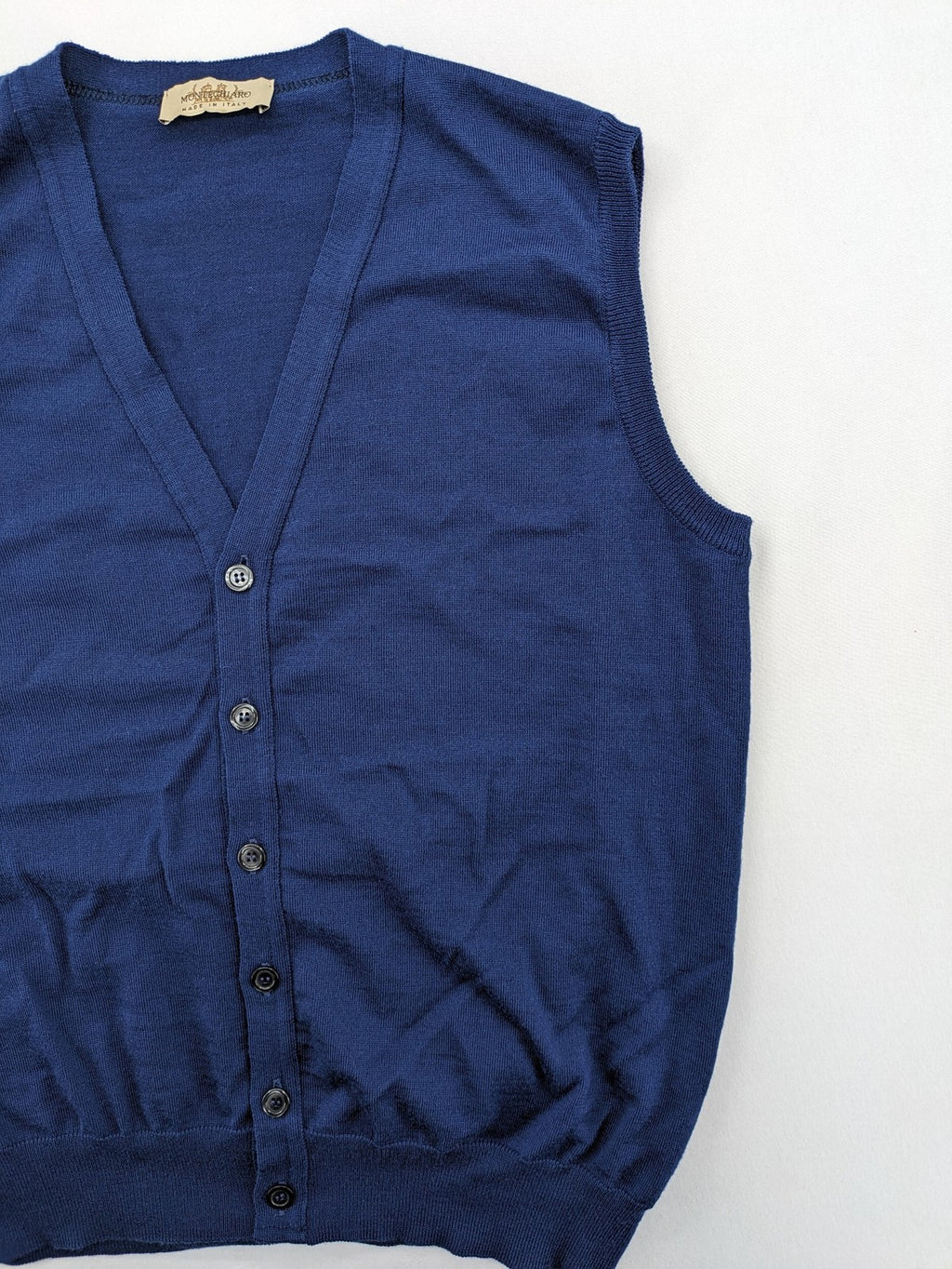 Montechiaro blue turtle neck jumper with V-neck, button placket, and sleeveless design.