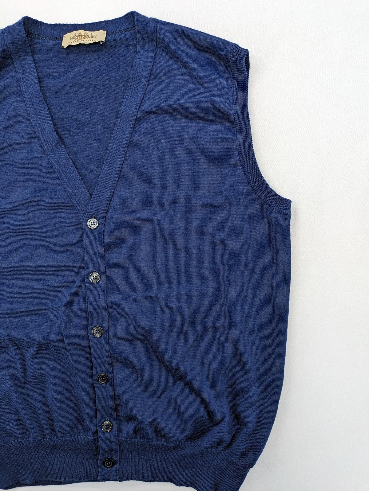 Montechiaro blue turtle neck jumper with V-neck, button placket, and sleeveless design.