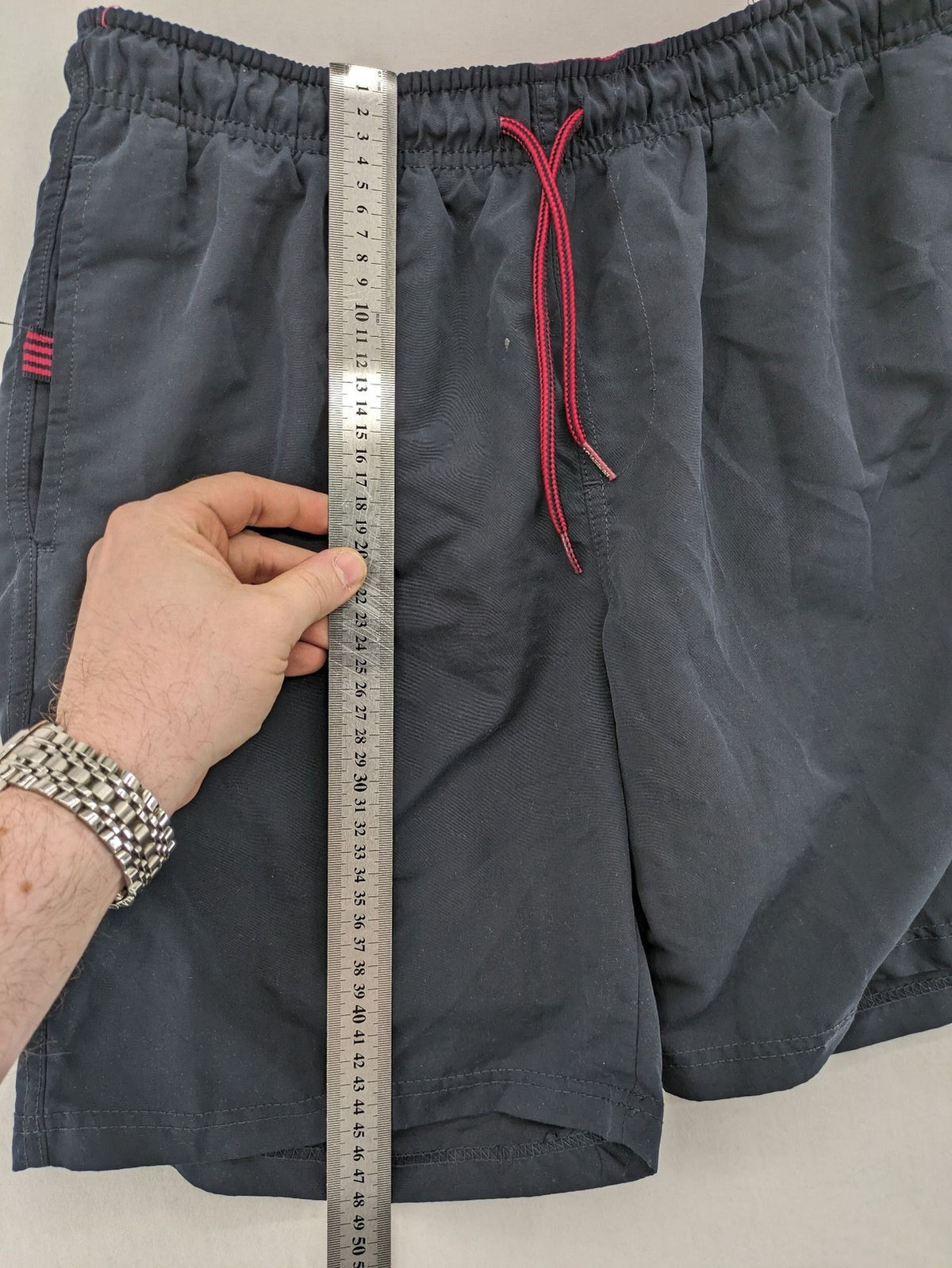 LC Waikiki navy swim shorts with red accents, elastic waistband, and quick-dry material.