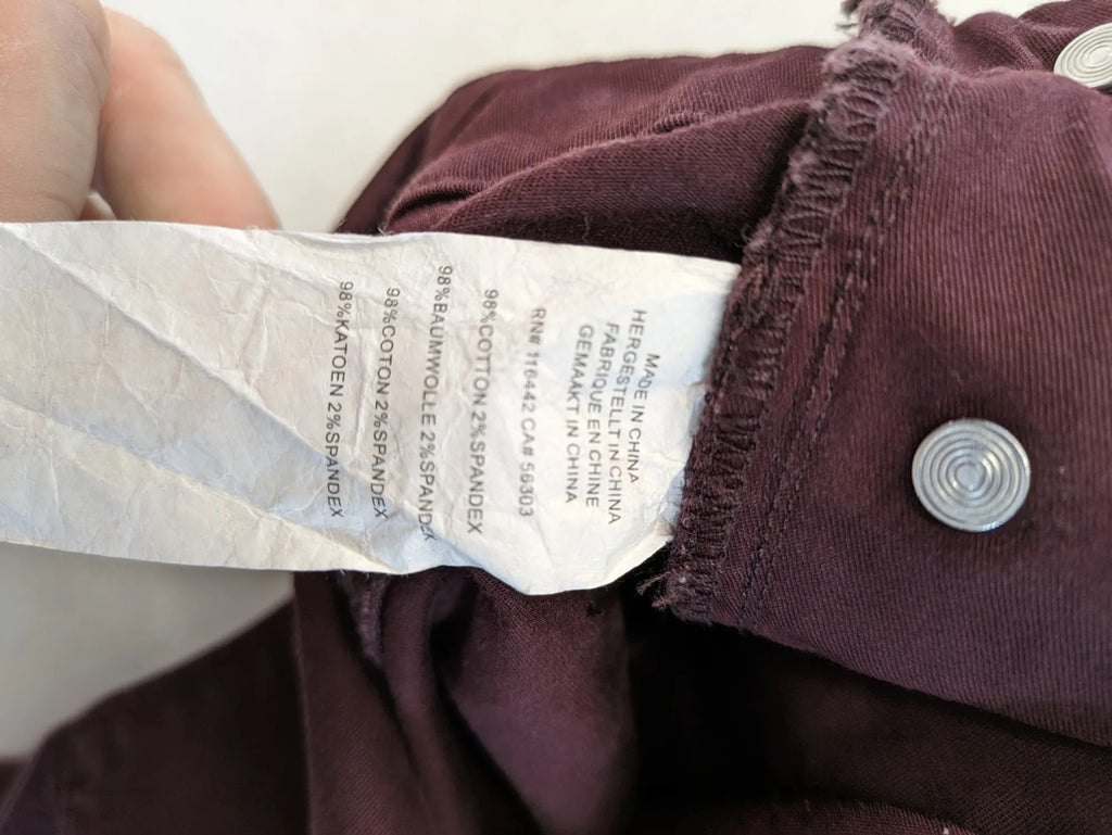 Kazane burgundy overalls with adjustable straps, side button placket, and chest pocket.