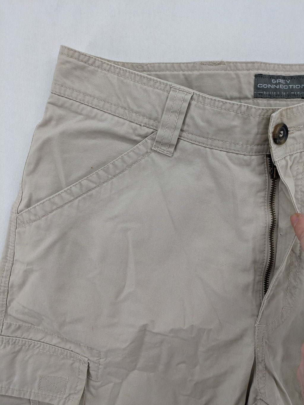 Grey Connection beige cargo shorts with multiple pockets and button closure, made from cotton.
