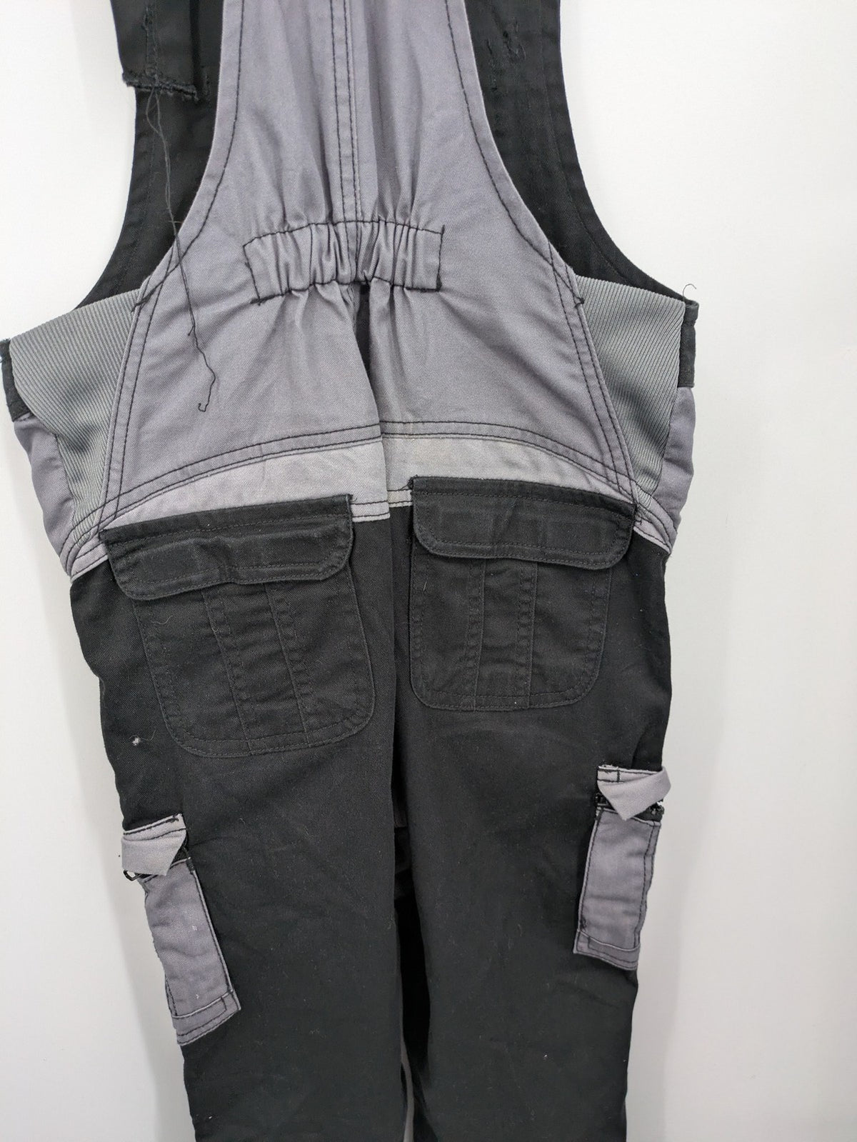 Cargo pants black grey two-tone design with red stitching and multiple pockets