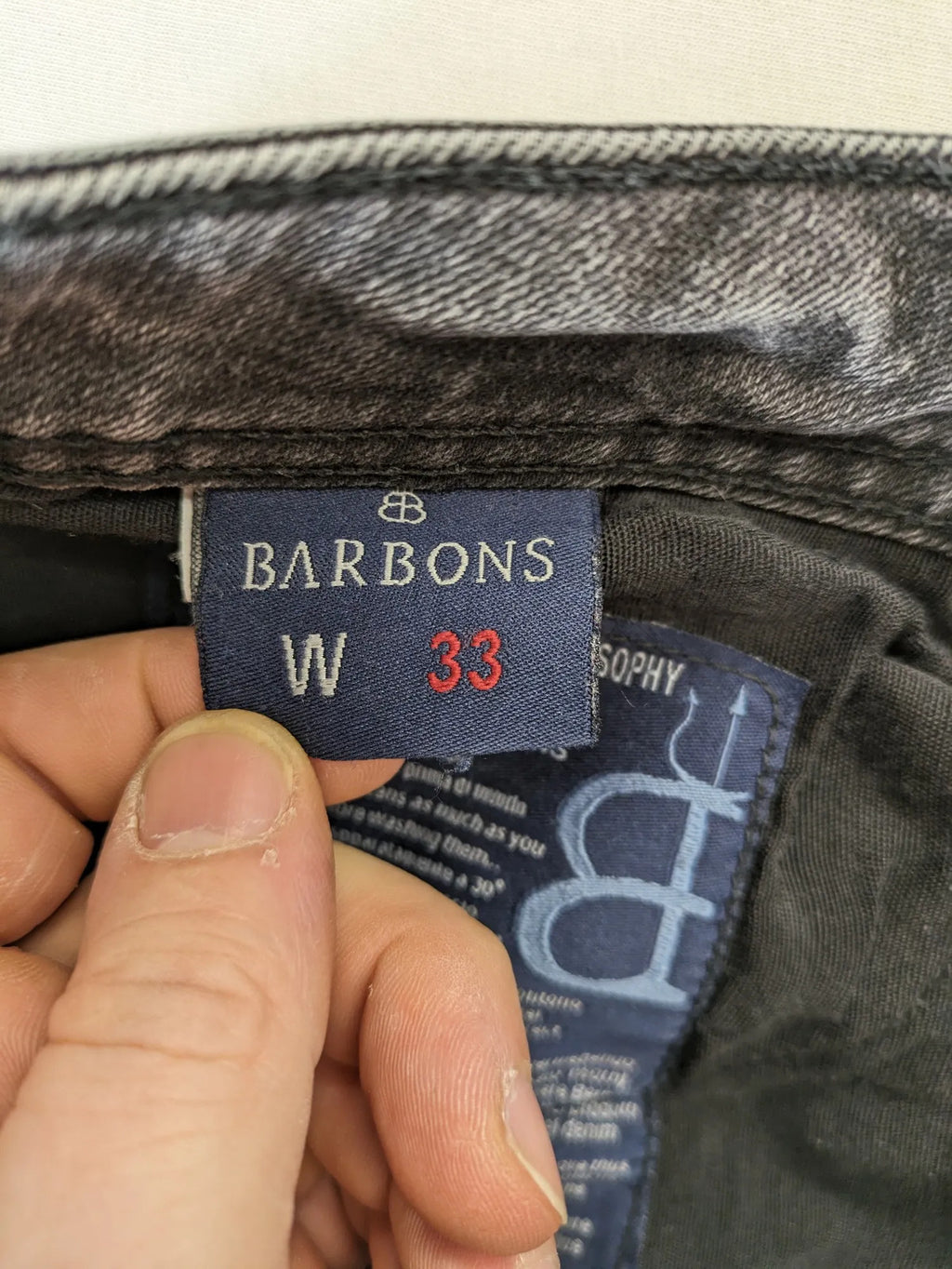 Denim grey straight jeans 5-pocket design with subtle brand details and zipper closure.