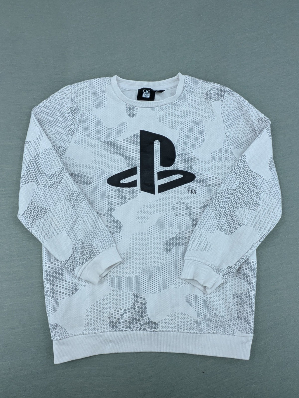 PlayStation grey sweatshirt with white logo and camo pattern featuring controller symbols.