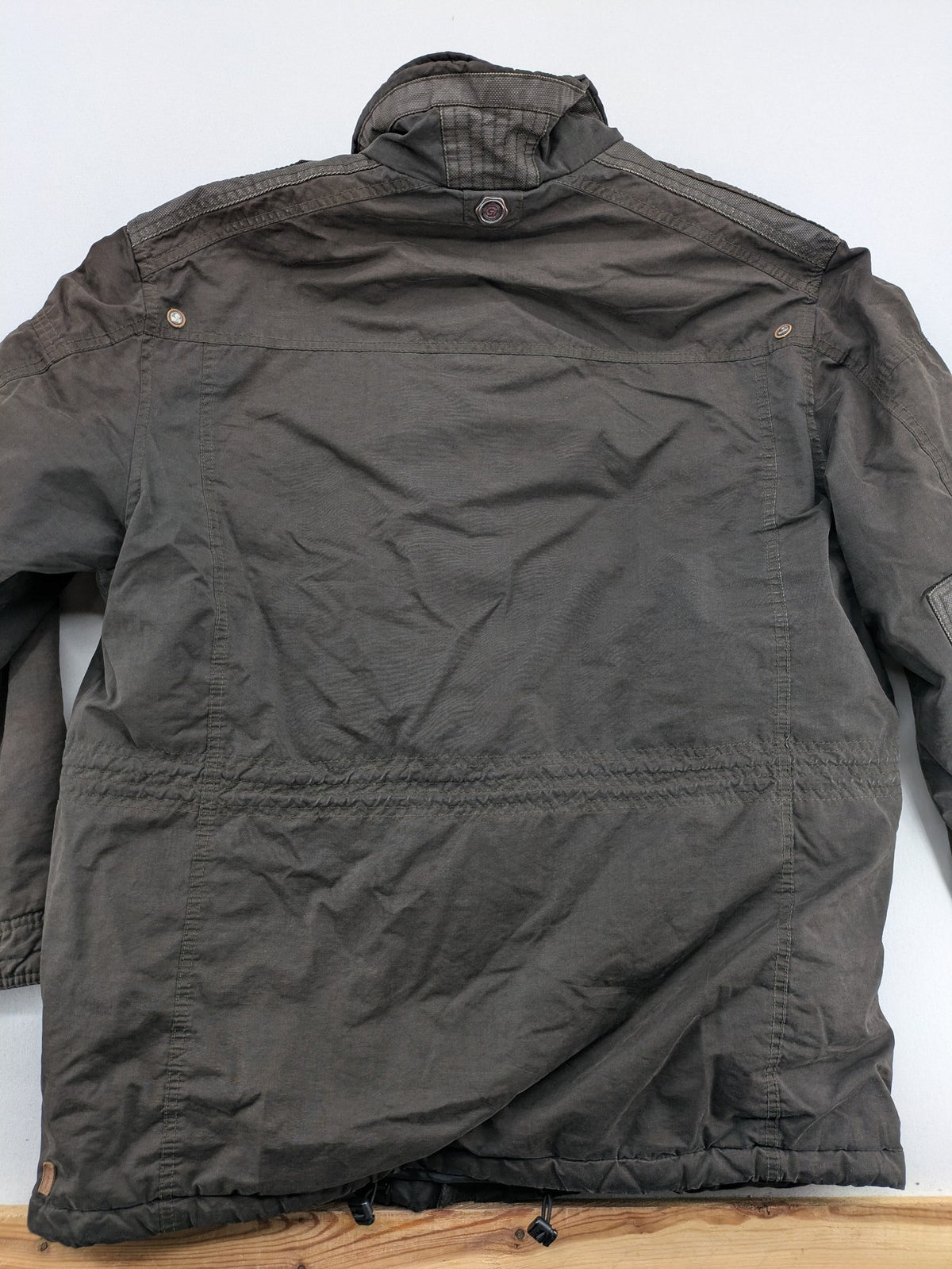 Gate One brown field jacket with plaid lining, multiple pockets, and zip-button closure.