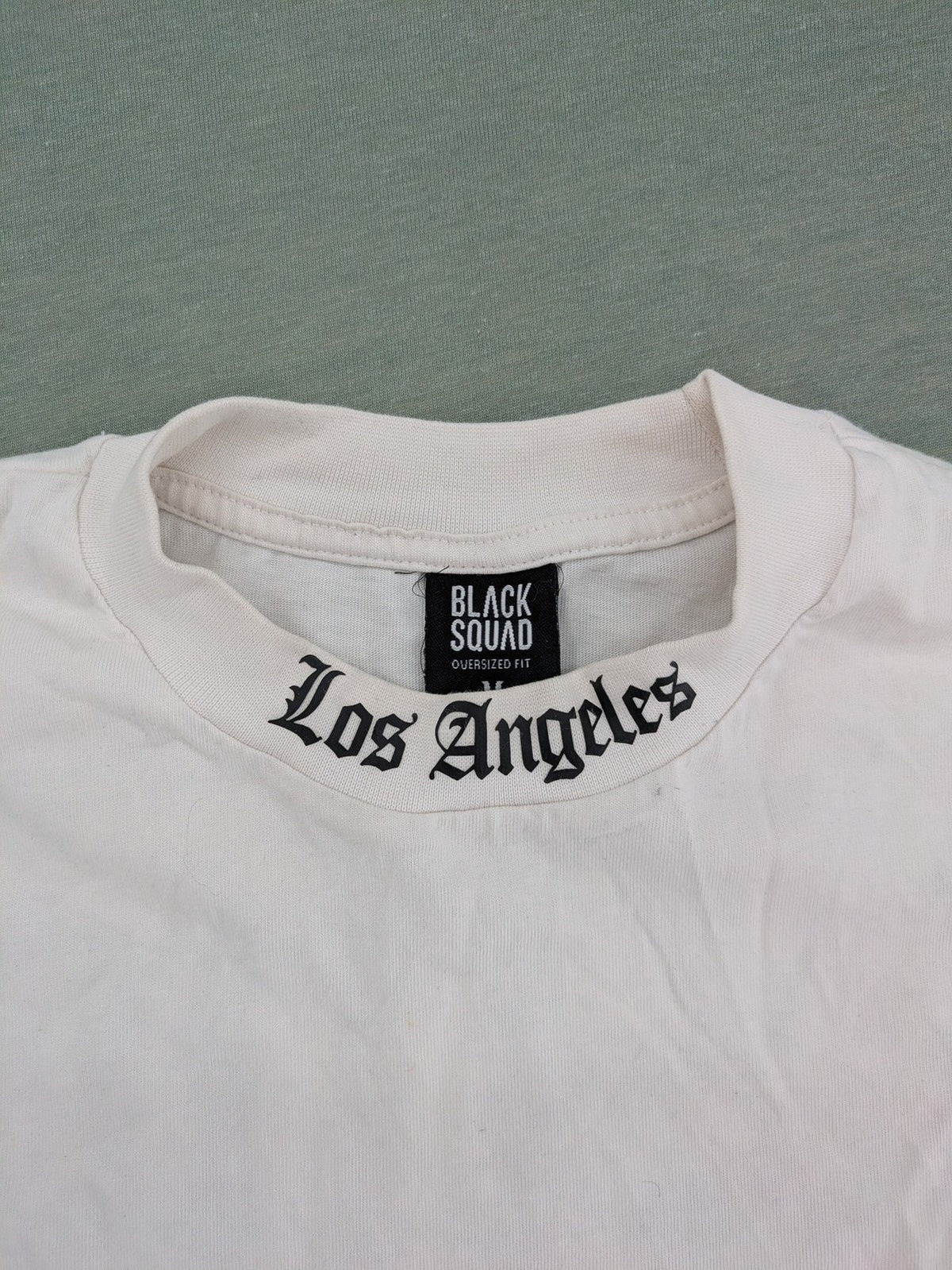 Black Squad black oversized t-shirt with white "Los Angeles" backprint and cotton material.