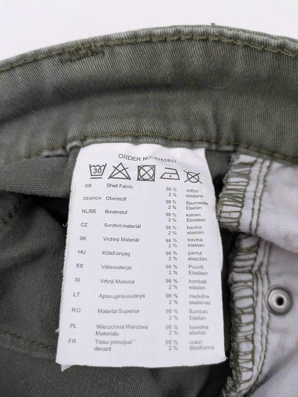 Page One Young khaki motorcycle pants with stitched panels and decorative zipper details.