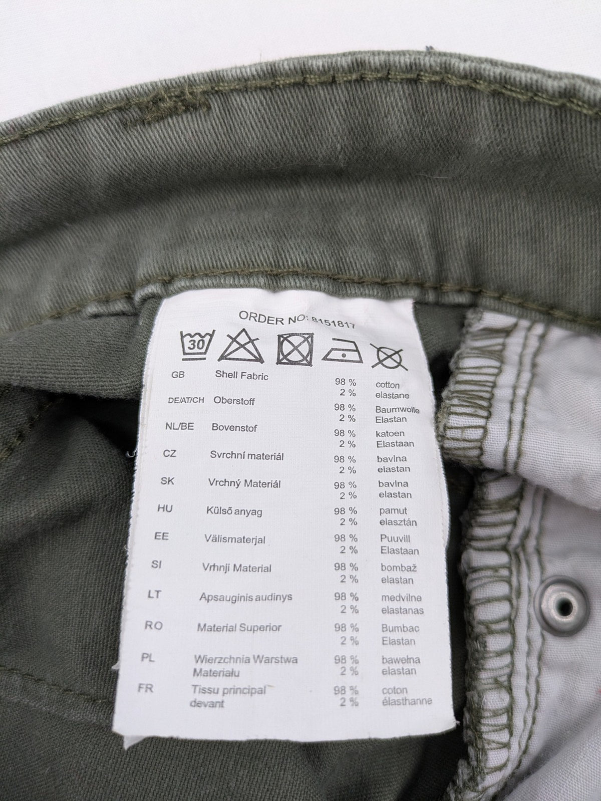 Page One Young khaki motorcycle pants with stitched panels and decorative zipper details.