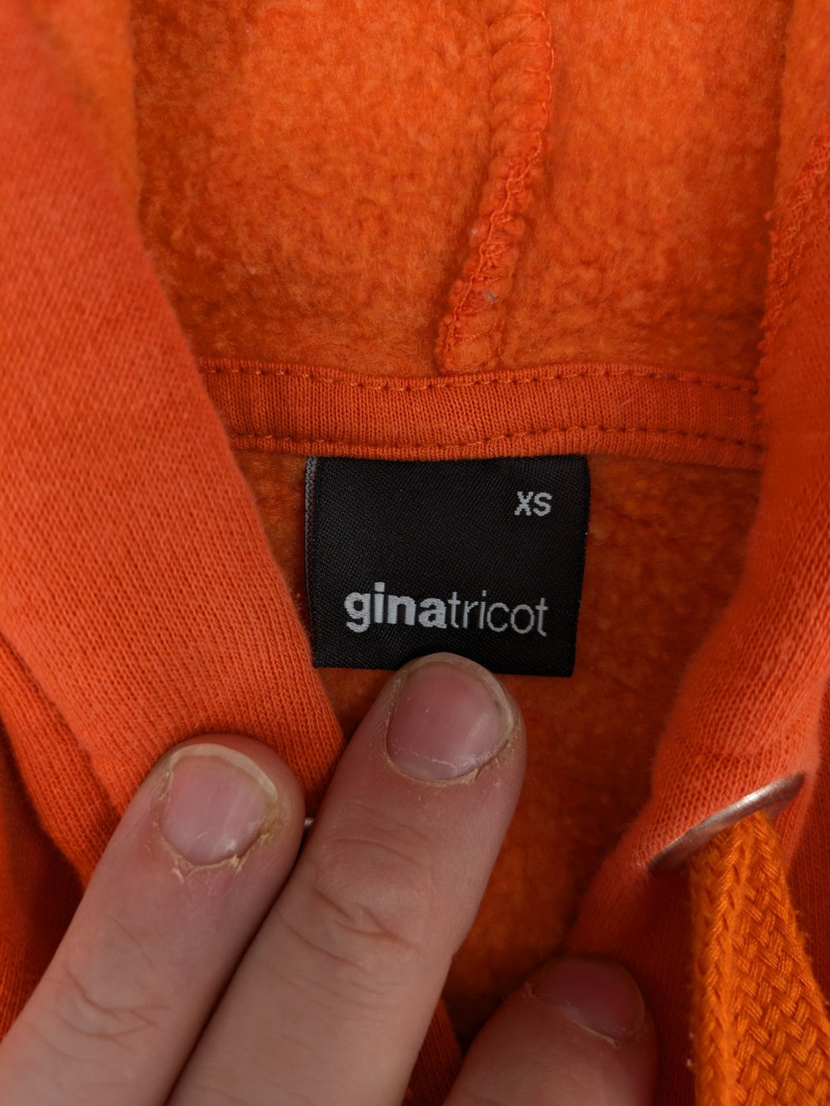 Ginatricot orange hoodie with embroidered winking eye detail, soft material, classic fit.