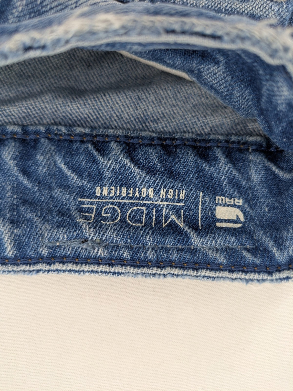 G-Star Raw blue distressed high boyfriend jeans with ripped details and classic button closure.