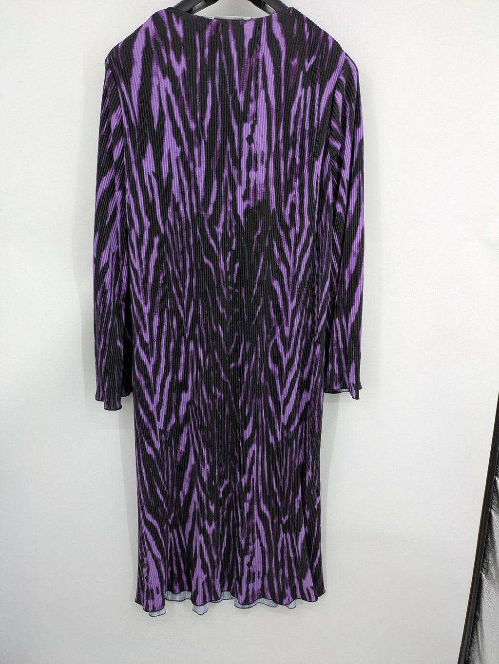 Untold black and purple pleated dress with animal print pattern and long sleeves.