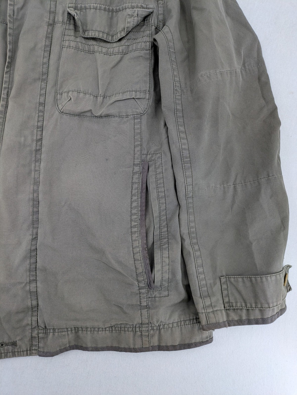 Walbusch khaki military jacket with checkered blue-white lining and multiple pockets.